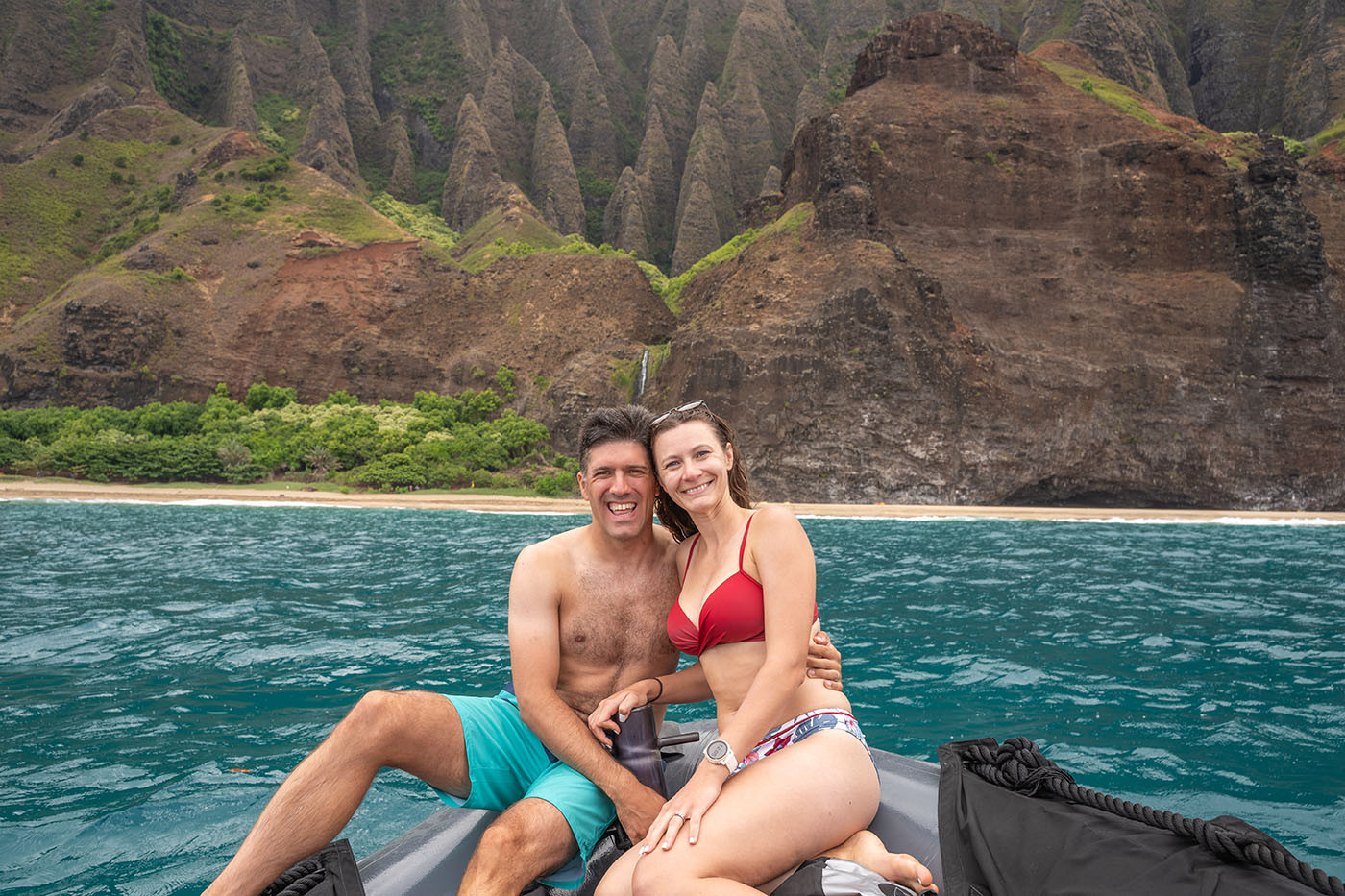 kalalau-valley-captain-andys.jpg Couple seated on the raft with Kalalau Valley and its waterfall behind them