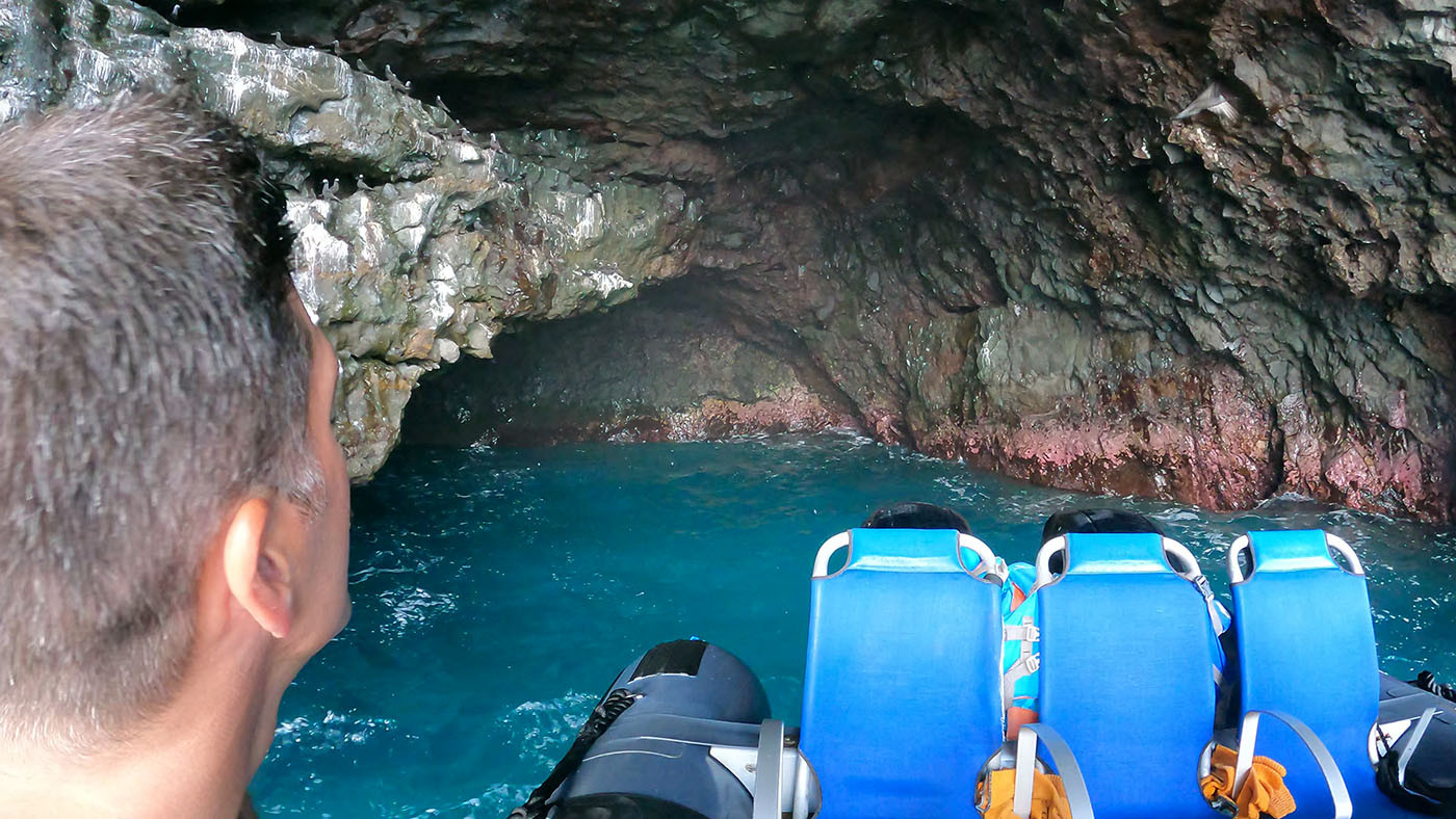 inside-sea-cave-na-pali-coast.jpg Tour raft entering a dark sea cave filled with vivid blue water