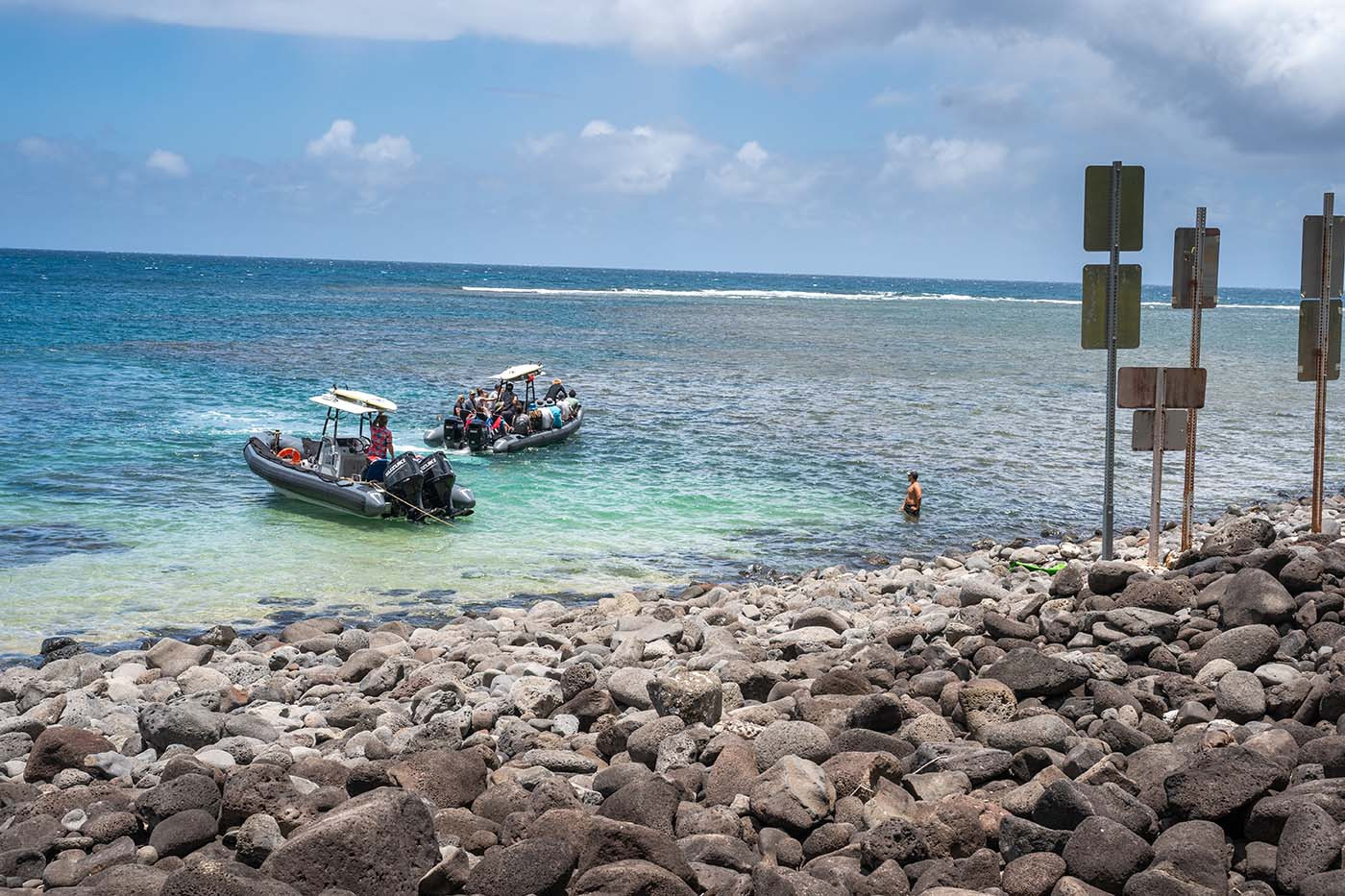 nu-alolo-kai-state-park-mooring.jpg Two rigid inflatable boats moored off the rocky shore at Nualolo Kai