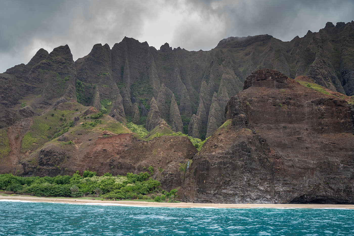 kalalau-valley.jpg Jagged ridges and a narrow waterfall rising behind Kalalau Beach