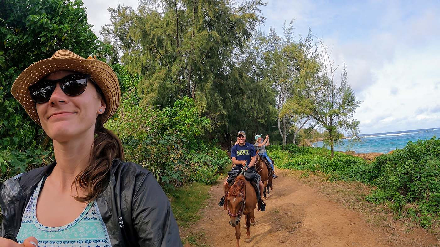 ocean-horseback-riding-kauai.jpg Rider taking a selfie as the group follows the coastal trail
