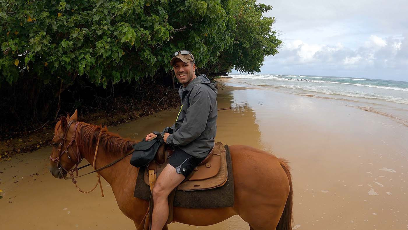 my-horse-gus.jpg Mike smiling on his trail horse Gus beside the beach