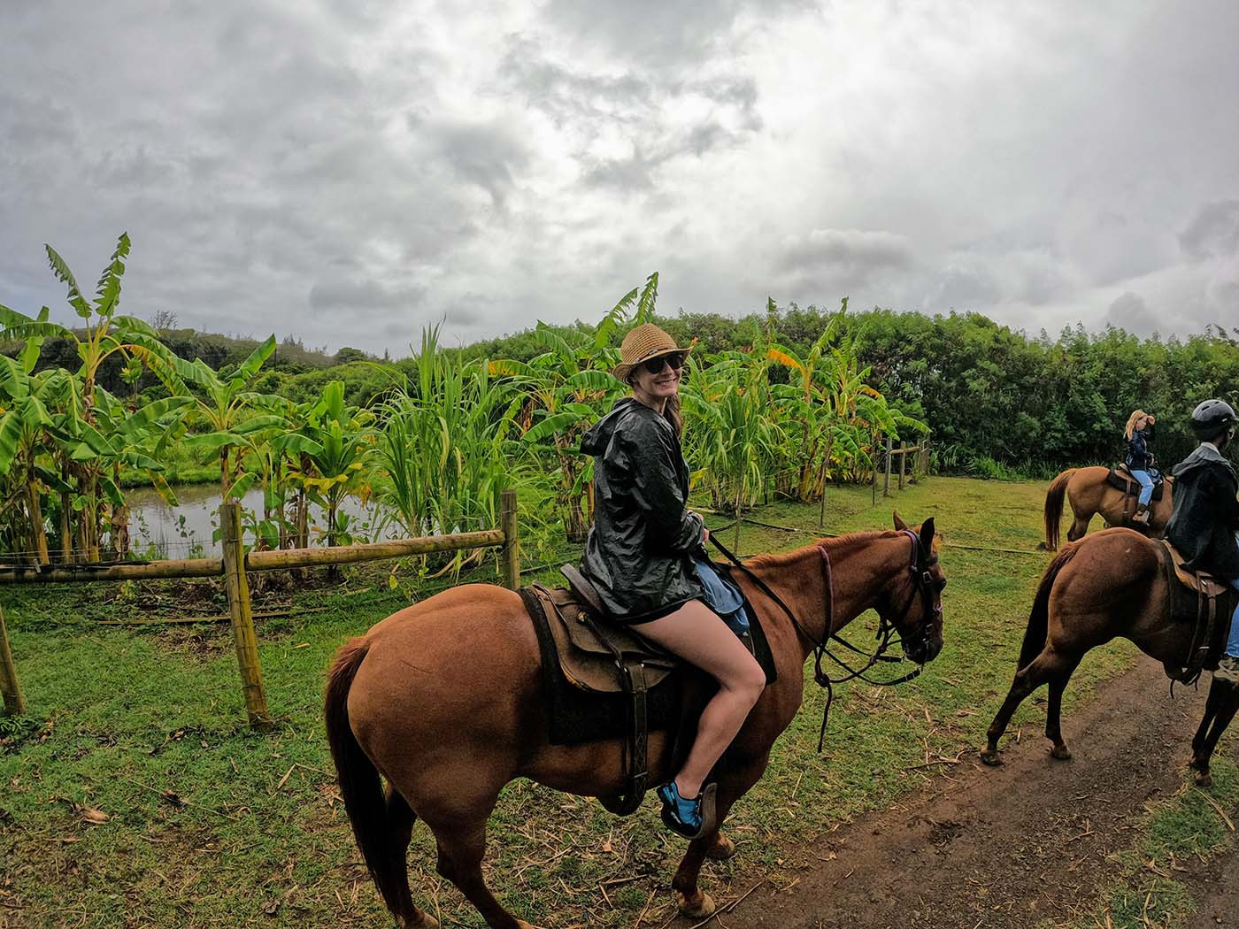 horseback-riding-kauai-inland.jpg Rider passing banana plants along the inland section of the trail