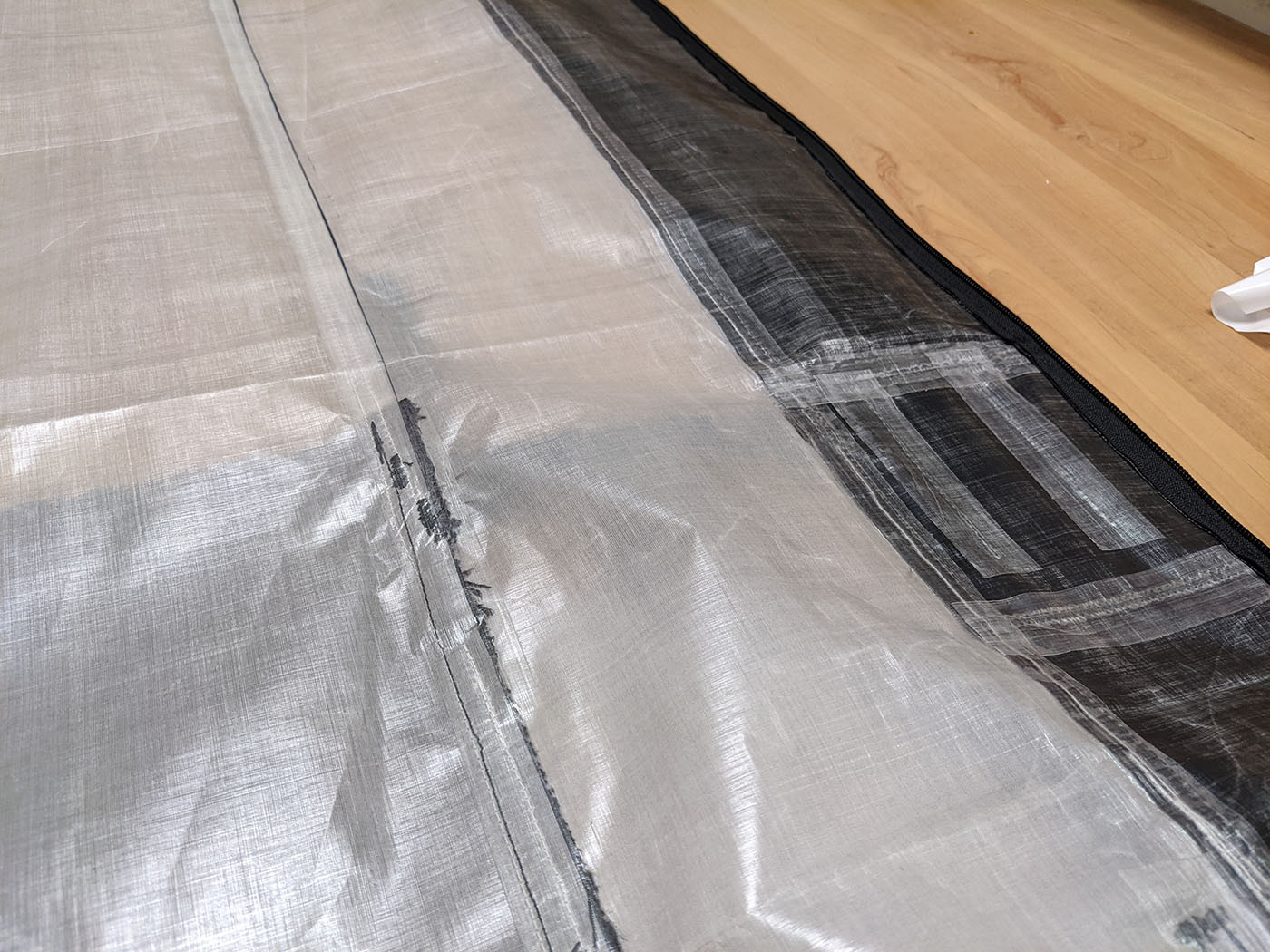Seam-sealing tape applied over the backpack's interior stitched seams