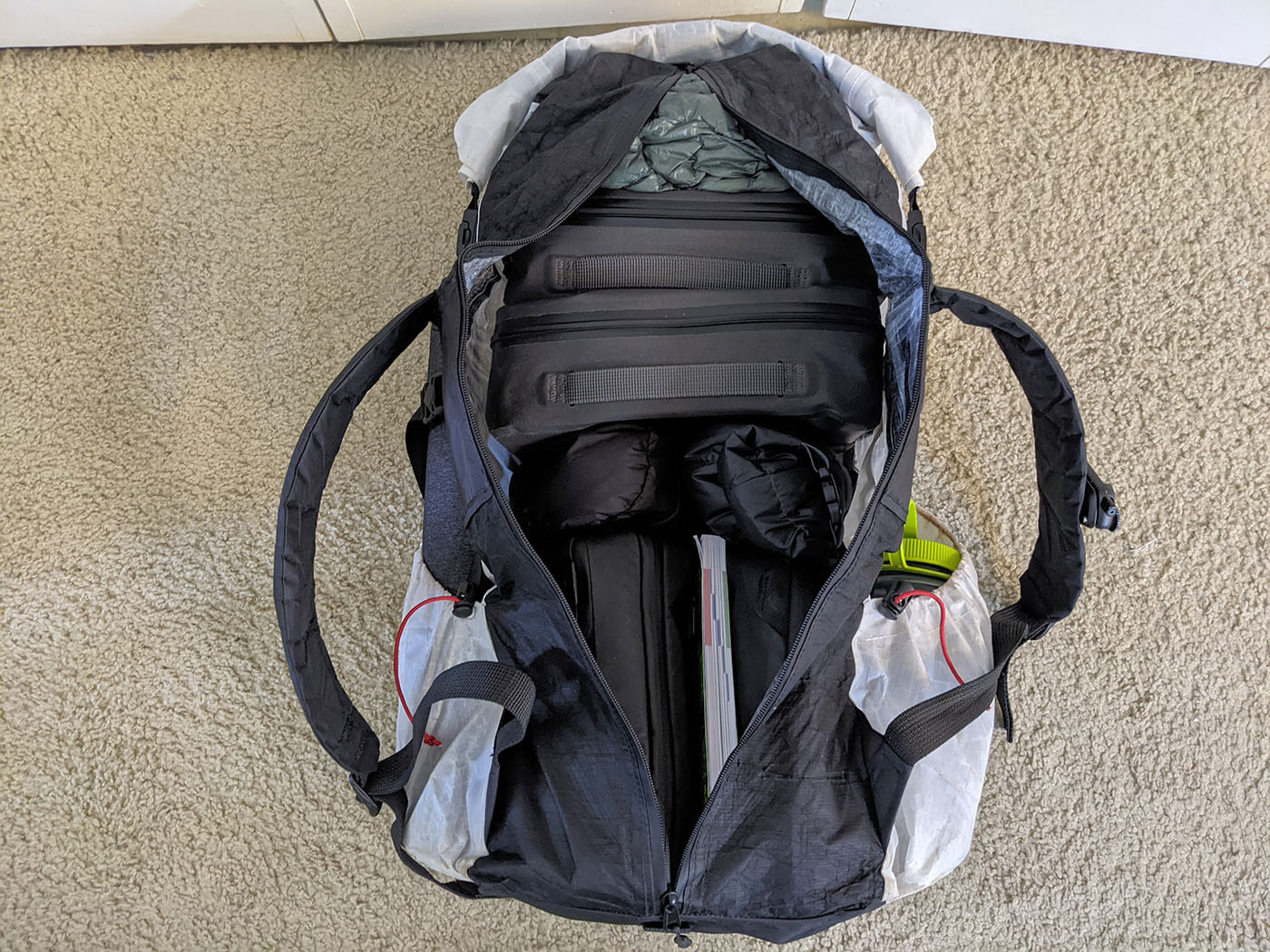 Open back zipper revealing the loaded interior of the Dyneema backpack