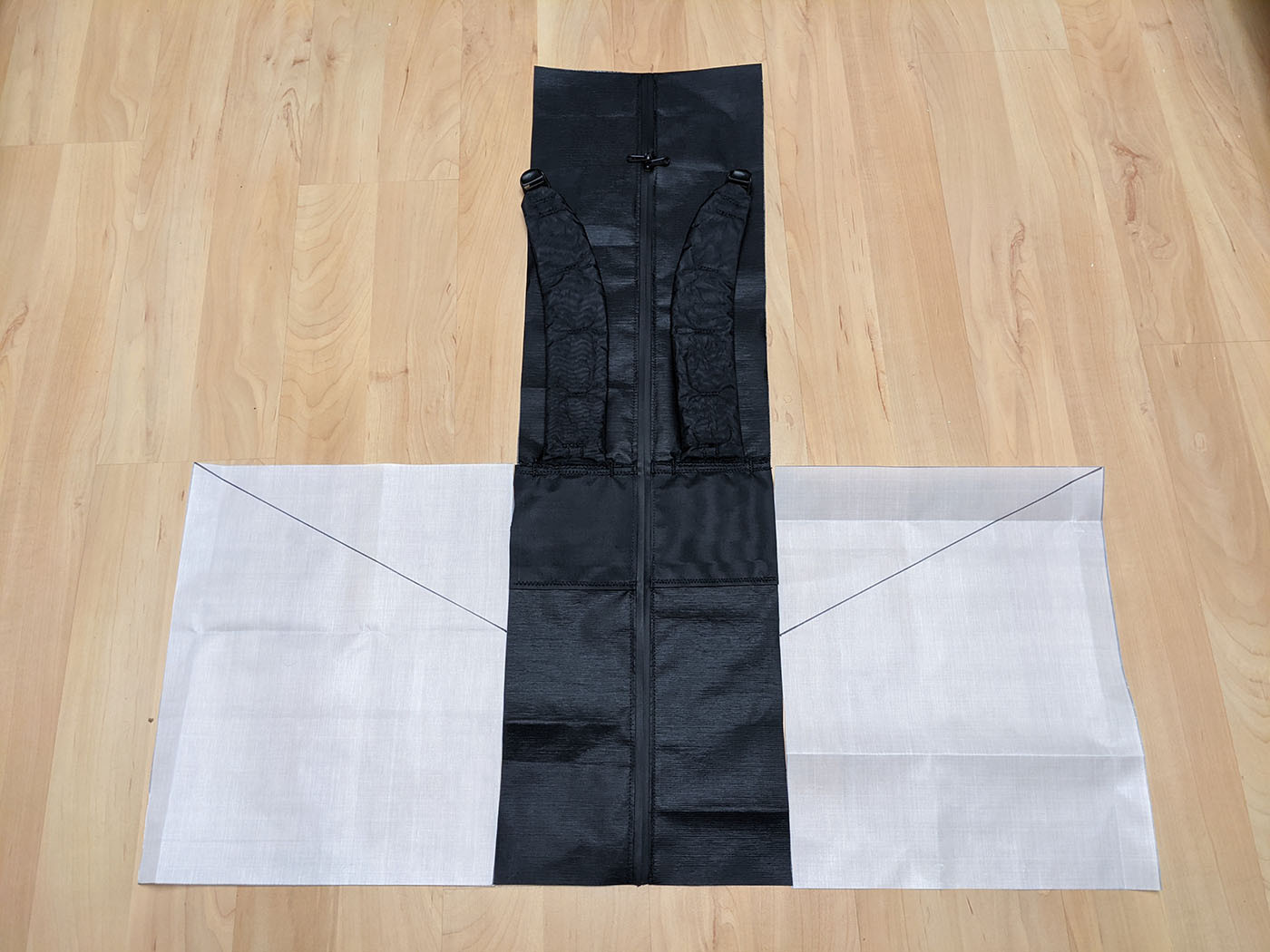 Back panel and white side panels laid flat before pocket assembly