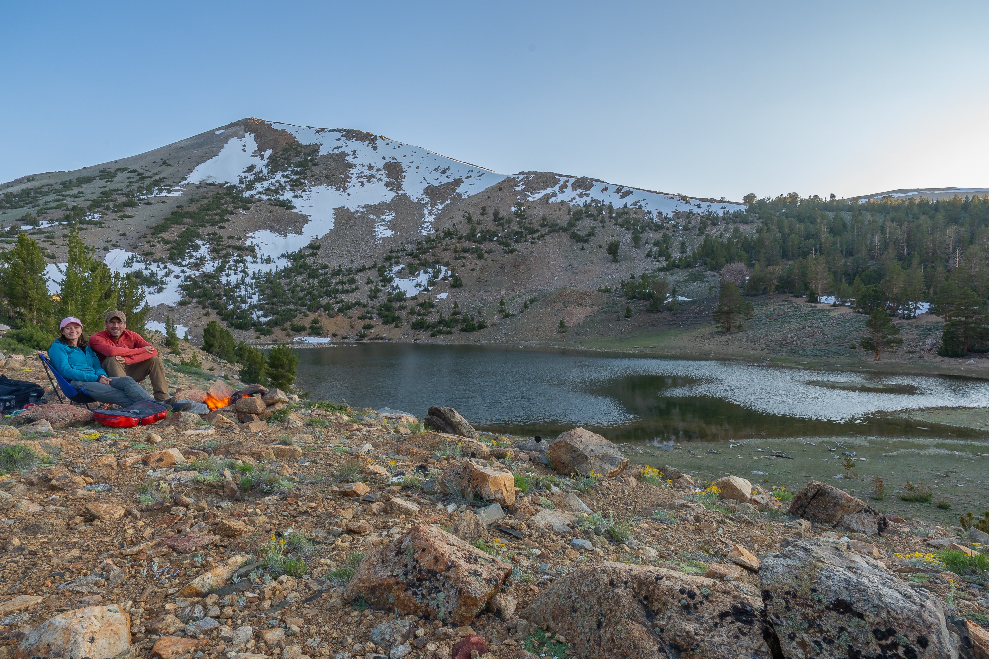 mcj07891.jpeg Campers beside a small fire overlooking Coyote Lake at dusk