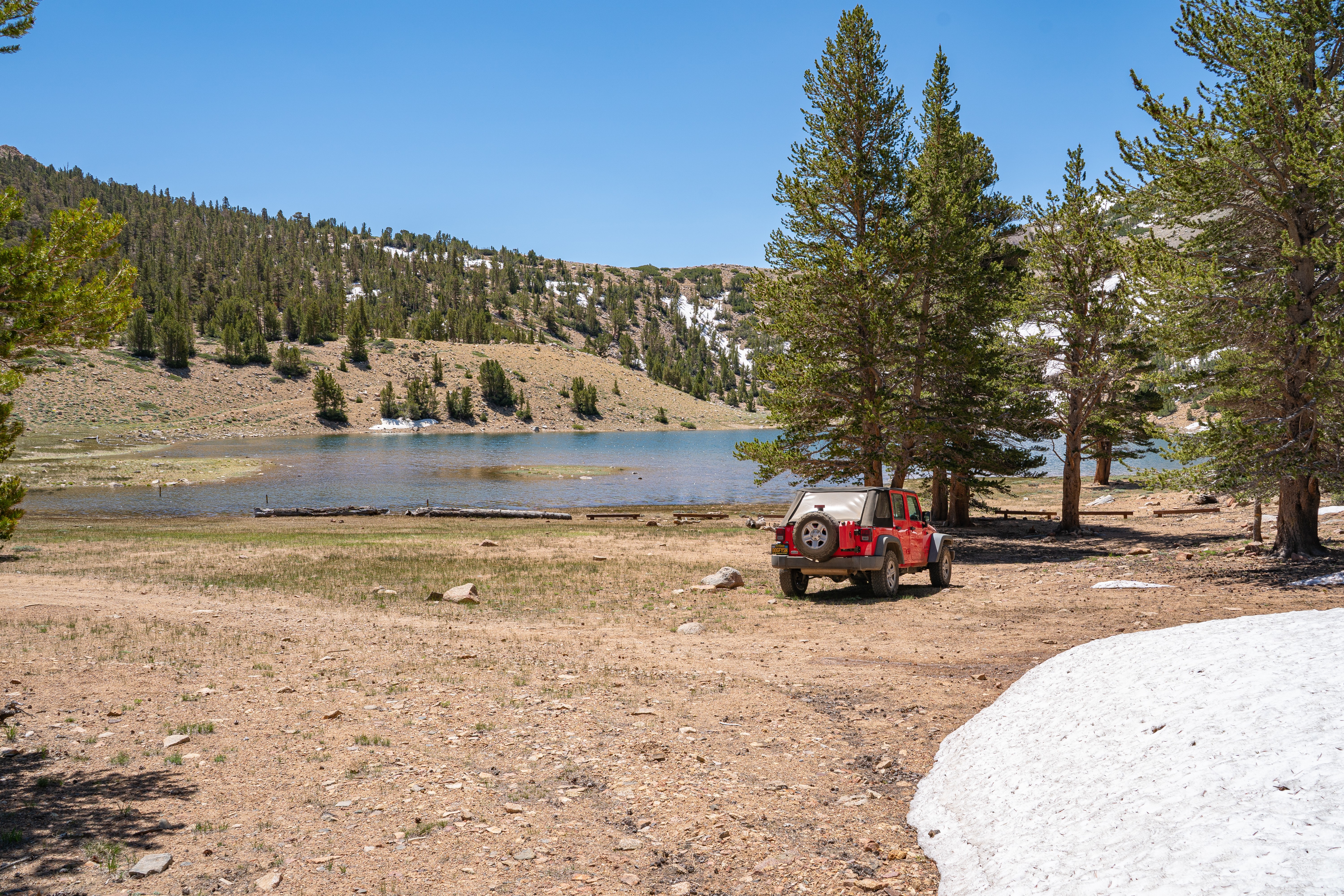 mcj07828.jpeg Red Jeep parked beside Coyote Lake below a snow-dotted ridge