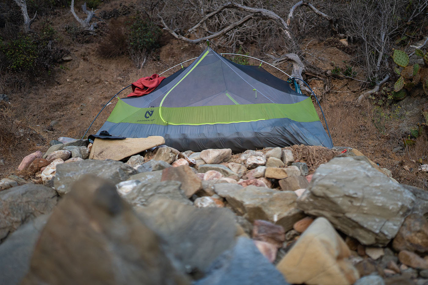 Tent sheltered behind a low rock wall at Italian Gardens 4