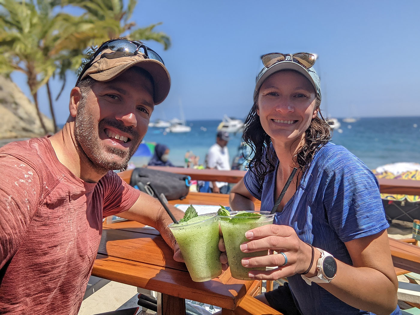 Two kayakers toast green mojitos after returning to Descanso Beach