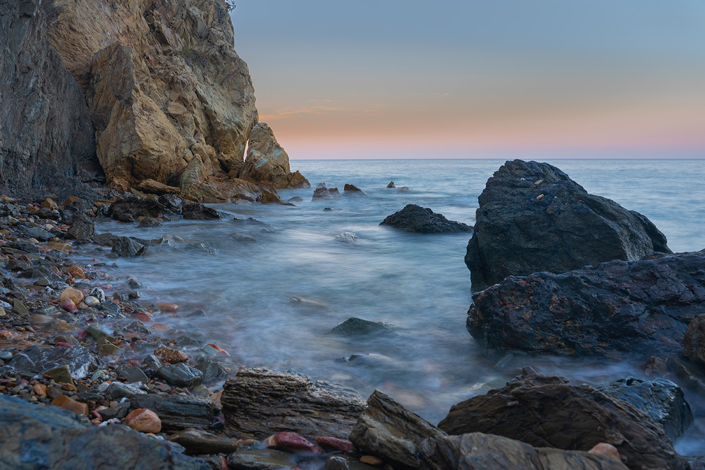 Long-exposure seascape of rocks and pastel twilight at Italian Gardens