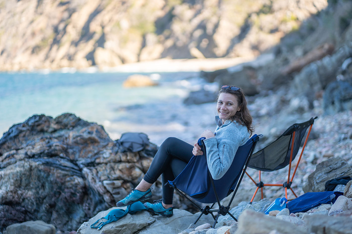 Camper relaxing in a chair on the secluded Italian Gardens beach