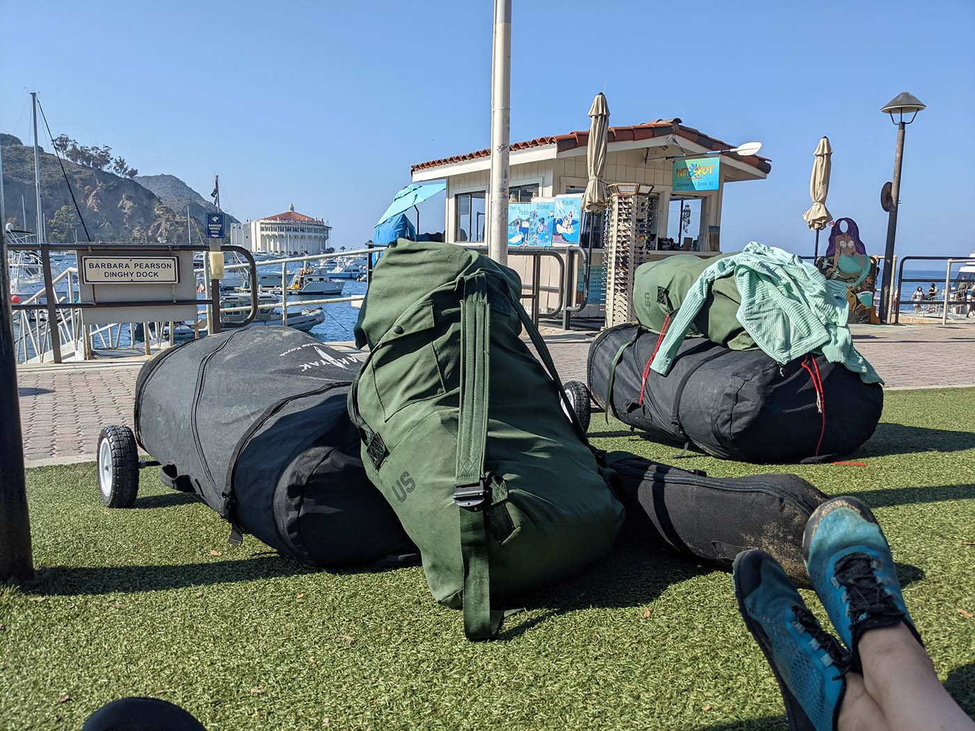 Packed Pakayak bags, paddle cases, and backpacks waiting near Avalon Harbor