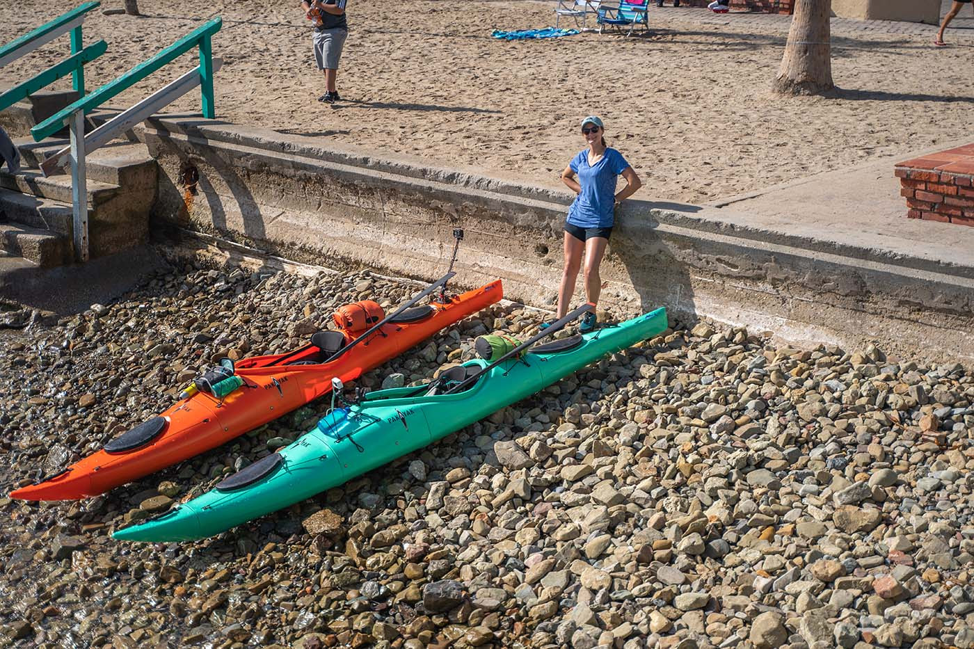 Loaded orange and teal Pakayaks at the rocky Avalon shoreline