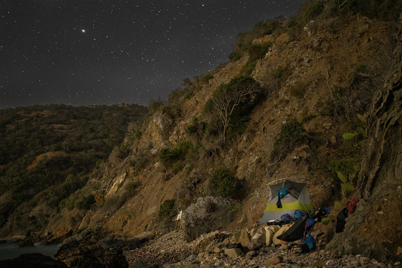 Star-filled night sky above the tent and rocky Italian Gardens campsite