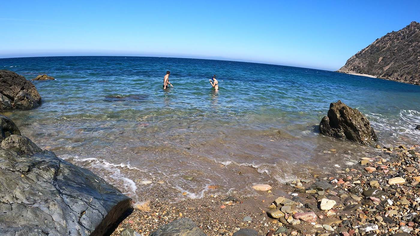 Two campers swimming in clear water off the Italian Gardens beach