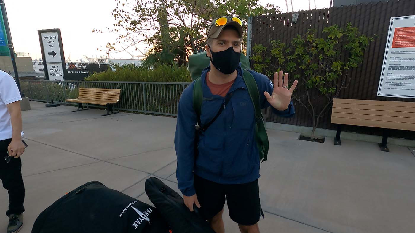 Kayaker waiting to board the Catalina ferry beside a packed Pakayak travel bag